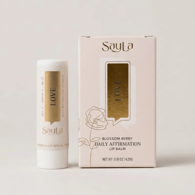 Sayla lip balm and packaging on a light gray background