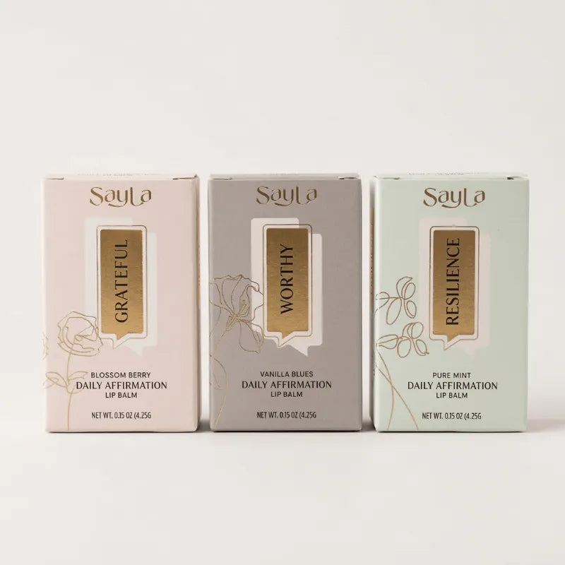 Three SayLa lip balm boxes on a white background