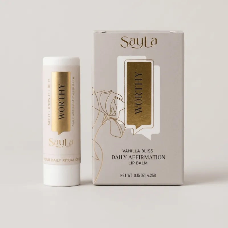 Sayla Worthy Vanilla Bliss Daily Affirmation Lip Balm with packaging on a light gray background