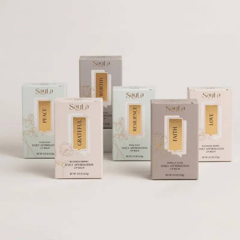 Collection of Sayla lip balm boxes on a light background