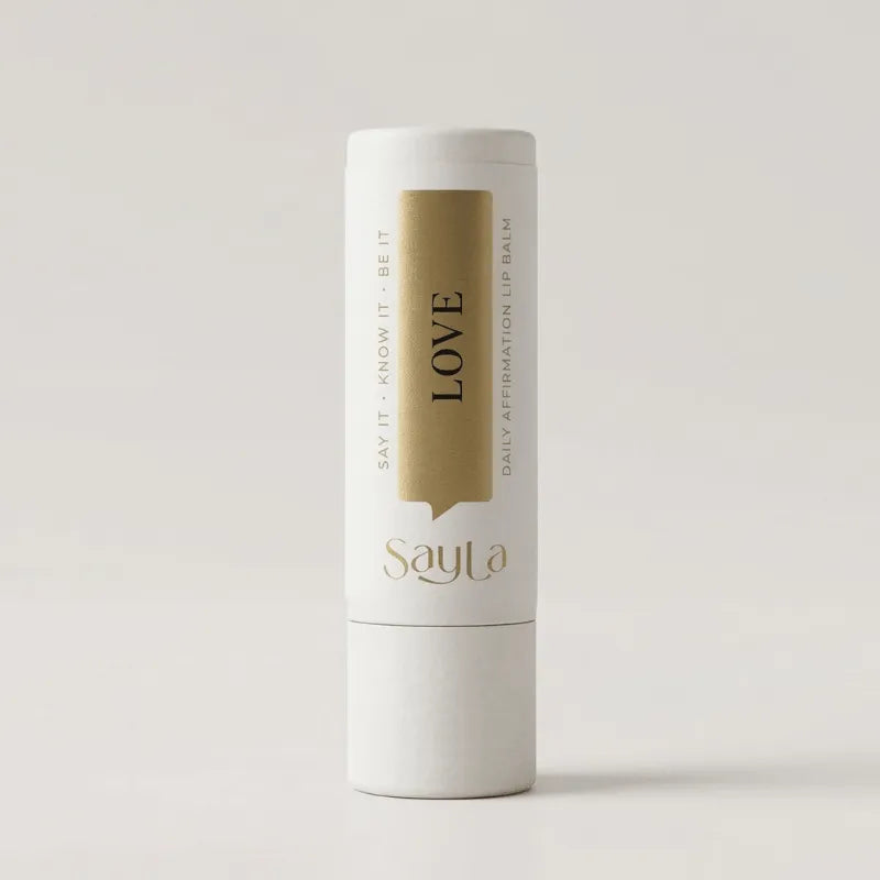 Sayla lip balm 'Love' variant on a light gray background
