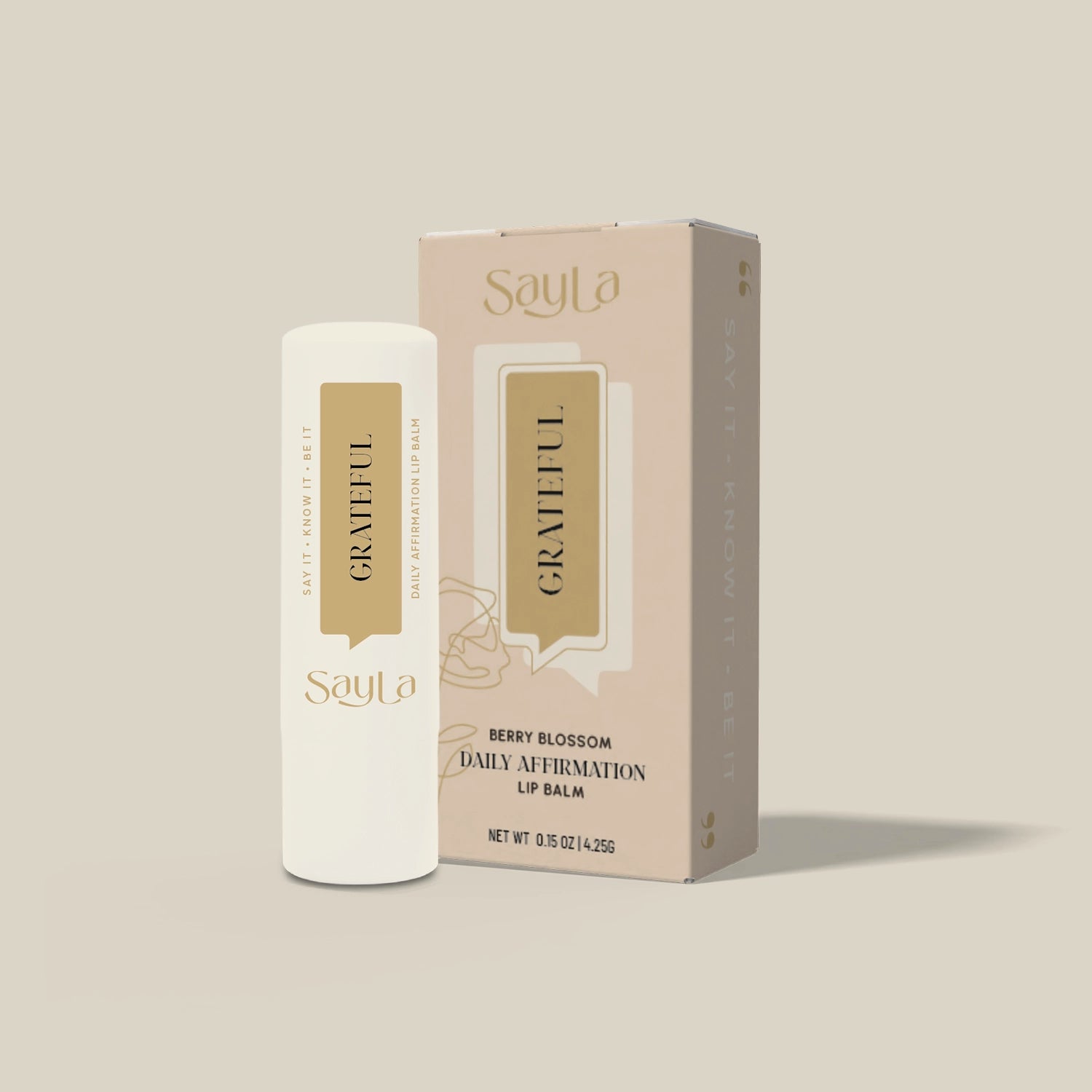 SayLa berry blossom lip balm with packaging on a beige background